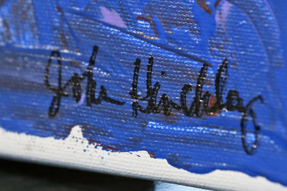 In this photo taken March 18, 2015, the signature on a painting by John Hinckley is seen in Hampton, Va. The man who tried to assassinate President Ronald Reagan may soon get the most freedom he's had since since the shooting outside a Washington hotel in 1981. (AP Photo/Steve Helber, File)