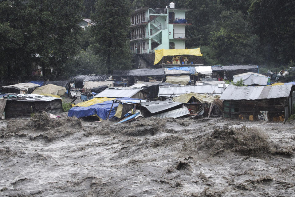 A swollen River Beas following heavy rains in Kullu, Himachal Pradesh, India, Sunday, July 9, 2023. According to local reports heavy rain fall has triggered landslides, damaged houses and caused loss of lives. (AP Photo/ Aqil Khan)