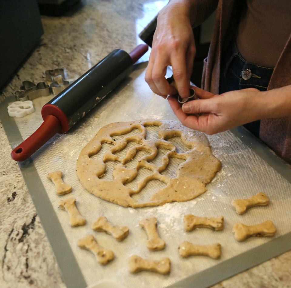 Penny Lansing makes a batch of organic peanut butter treats, one of 11 different kinds of treats.