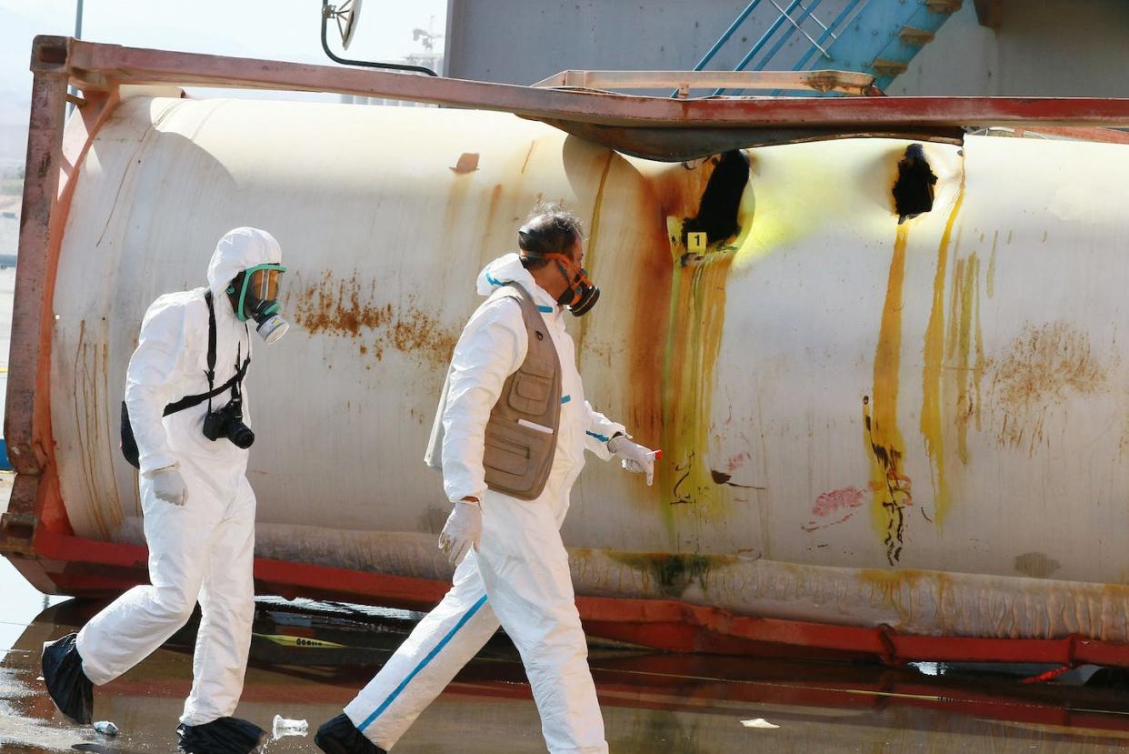 Jordanian forensics experts inspect the site of a chlorine gas explosion in the Port of Aqaba in June 2022. <a href="https://www.gettyimages.com/detail/news-photo/jordanian-forensics-experts-inspect-the-site-of-a-toxic-gas-news-photo/1241583752" rel="nofollow noopener" target="_blank" data-ylk="slk:Khalil Mazraawi/AFP via Getty Images;elm:context_link;itc:0;sec:content-canvas" class="link ">Khalil Mazraawi/AFP via Getty Images</a>
