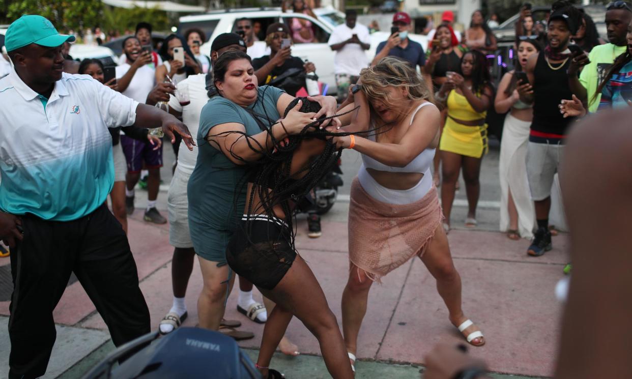 <span>Women fight on the street near Ocean Drive in Miami Beach, Florida, on 19 March 2021.</span><span>Photograph: Joe Raedle/Getty Images</span>