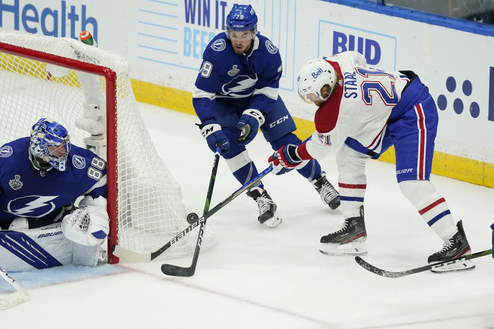 Tampa Bay Lightning left wing Ross Colton (79) breaks up the pass by Montreal Canadiens center Eric Staal (21) during the third period in Game 2 of the NHL hockey Stanley Cup finals, Wednesday, June 30, 2021, in Tampa, Fla. (AP Photo/Gerry Broome)