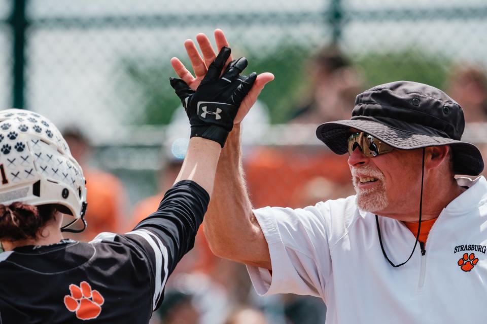 Strasburg's Hayley Reiger is congratulated by Head coach Tom Spidell Jr., after hitting a two-run home run to left field during their Division IV  regional championship on Saturday.