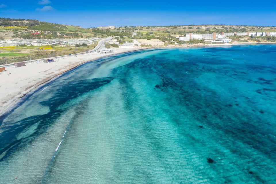 Mellieha Bay in Malta (Alamy/PA)