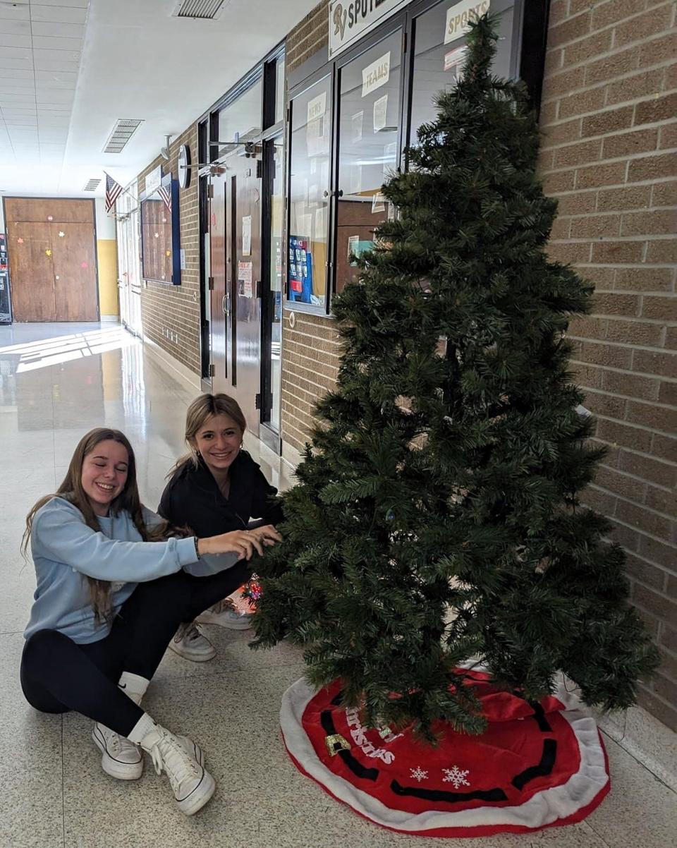 Mar Arteaga of Spain and Laynee Lowe decorate a Christmas tree at River View High School. Their senior project included decorating the school inside and out for holidays.