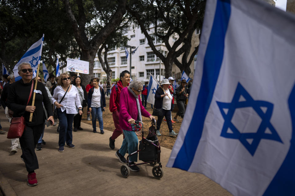 Israeli "grandmothers for democracy" protest plans by Prime Minister Benjamin Netanyahu's government to overhaul the judicial system, saying the planned reform is worrying for the future of the country, in Tel Aviv, Israel, Wednesday, March 22, 2023. (AP Photo/Oded Balilty)