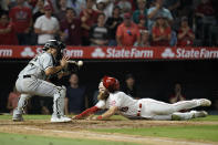 Los Angeles Angels' Brandon Marsh, right, slides into home plate against Chicago White Sox catcher Seby Zavala to score on a double by Taylor Ward during the seventh inning of a baseball game Monday, June 27, 2022, in Anaheim, Calif. (AP Photo/Jae C. Hong)