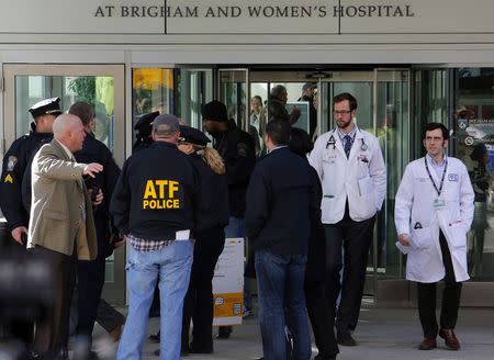 Local, state and federal law enforcement officials gather outside the building where a shooting occurred at Brigham and Women's hospital in Boston, Massachusetts January 20, 2015. REUTERS/Brian Snyder