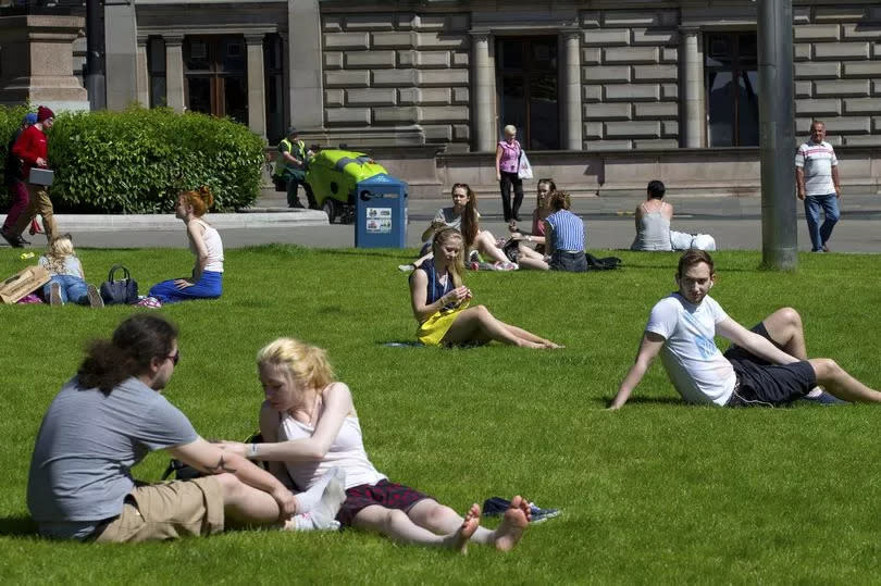 sun worshippers enjoy the rays in George Square Glasgow