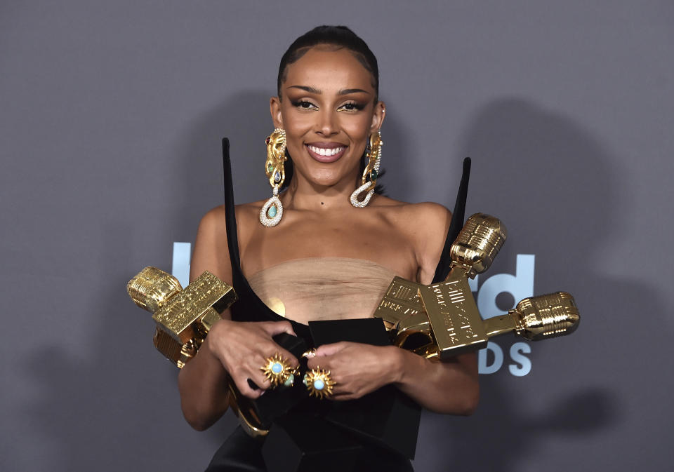 Doja Cat poses in the press room with the awards for top R&B artist, top R&B female artist, top viral song for "Kiss Me More" and top R&B album for "Planet Her" at the Billboard Music Awards on Sunday, May 15, 2022, at the MGM Grand Garden Arena in Las Vegas. (Photo by Jordan Strauss/Invision/AP)