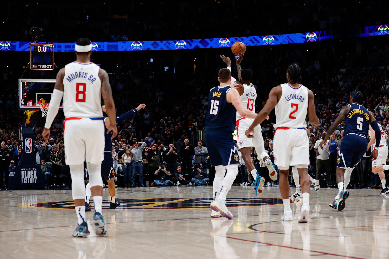 Feb 26, 2023; Denver, Colorado, USA; Los Angeles Clippers forward Paul George (13) is unable to release a three point shot before the clock expires as Denver Nuggets center Nikola Jokic (15) and forward Marcus Morris Sr. (8) and forward Kawhi Leonard (2) and guard Kentavious Caldwell-Pope (5) look on at the end of the fourth quarter at Ball Arena. Mandatory Credit: Isaiah J. Downing-USA TODAY Sports
