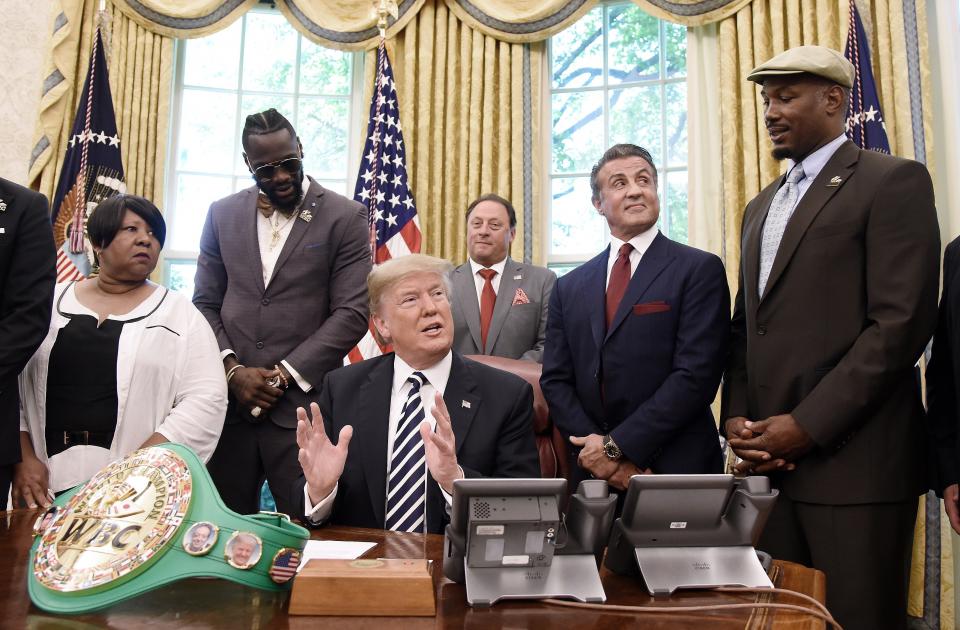 Donald Trump speaks after granting posthumous pardon to former heavyweight champion Jack Johnson in the Oval Office on May 24. Attending the event are (left to right) Linda Haywood, Great great niece of Jack Johnson, Deontay Wilder, Keith Frankel, Sylvester Stallone, and Lennox Lewis. (Photo: Pool via Getty Images)