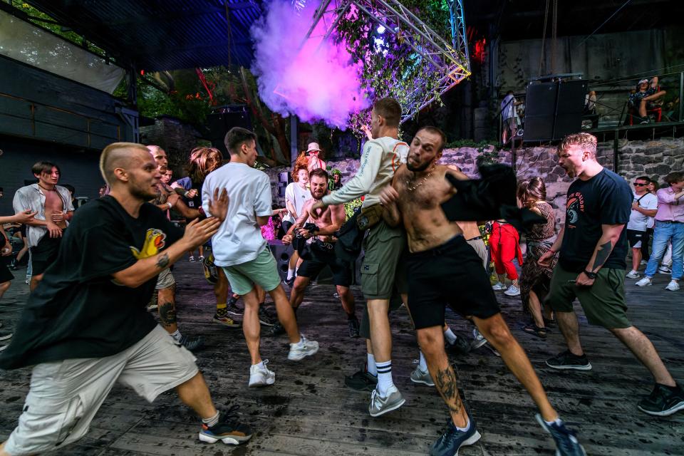 Revellers crash into each other in the "mosh pit" during a rave party in central Kyiv, Ukraine August 27, 2022.