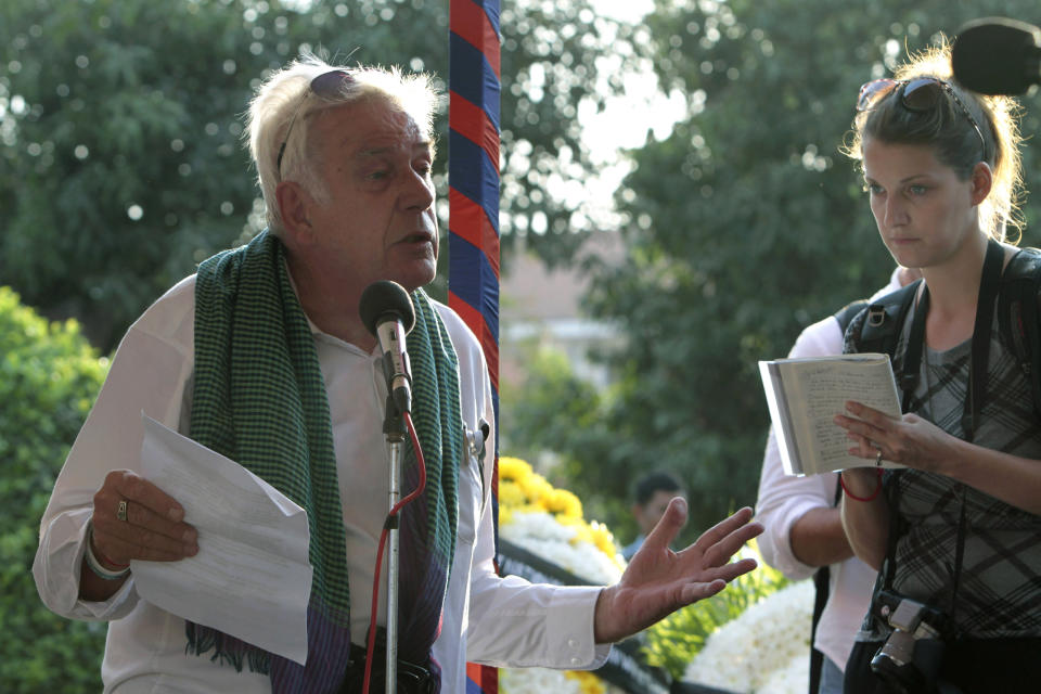 FILE - Tim Page, a former war photographer, left, gives a speech during the unveiling of a memorial plaque dedicated to correspondents and journalists killed and missing in 1970-75 in the Cambodian War, in Phnom Penh, Cambodia on Feb. 6, 2013. Legendary Vietnam War photographer, writer and counter-culture documenter Tim Page died Wednesday, Aug. 24, 2022 at his Australian home. He was 78 years old. (AP Photo/Heng Sinith, File)