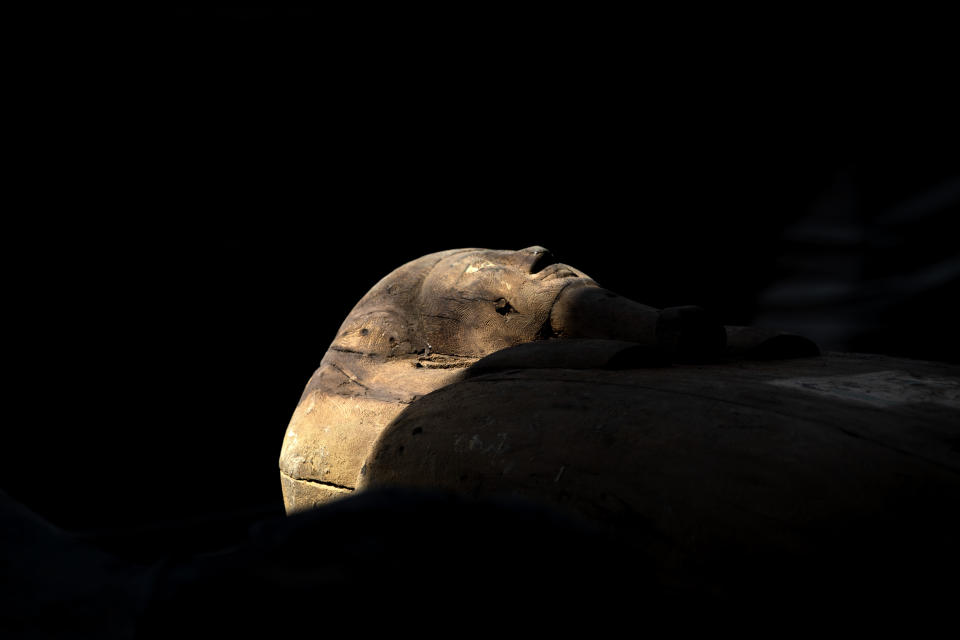A sarcophagus that is around 2500 years old is shown at the Saqqara archaeological site, 30 kilometers (19 miles) south of Cairo, Egypt, Saturday, Oct. 3, 2020. Egypt says archaeologists have unearthed about 60 ancient coffins in a vast necropolis south of Cairo. The Egyptian Tourism and Antiquities Minister says at least 59 sealed sarcophagi with mummies inside were found that had been buried in three wells more than 2,600 years ago. (AP Photo/Mahmoud Khaled)