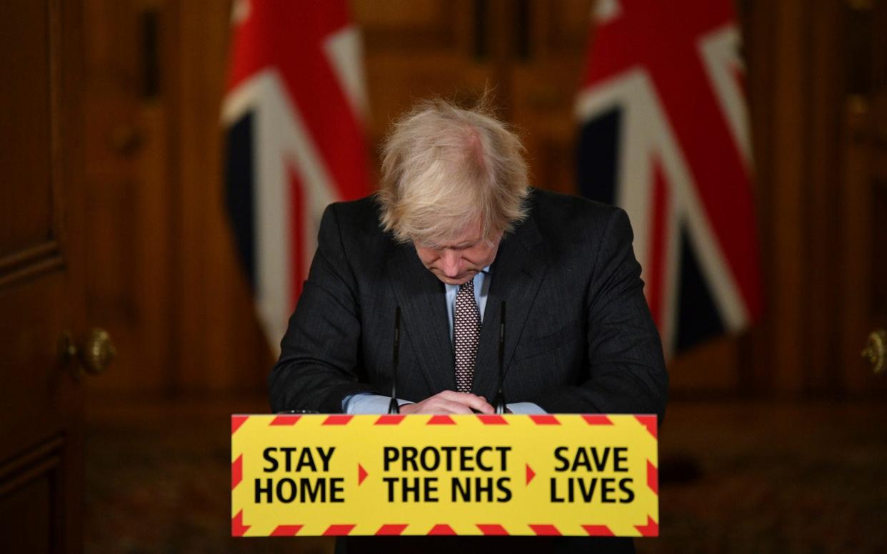 Boris Johnson bows his head as he confirms that the UK's coronavirus death toll has passed 100,000 people -  Justin Tallis/AFP