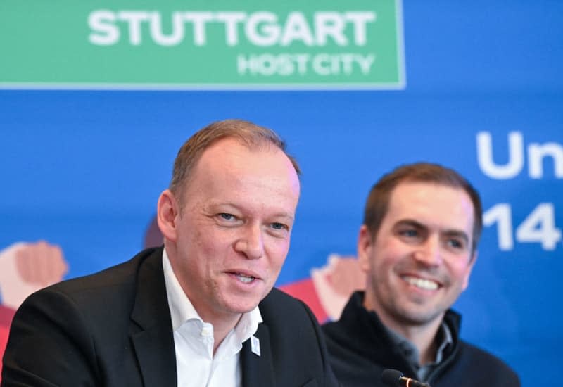 Markus Stenger (L), Managing Director of EURO 2024 GmbH and Philipp Lahm, Tournament Director of the European Football Championship 2024, sit on the podium in front of the Stuttgart logo of the European Championship at a press conference in the town hall. Bernd Weißbrod/dpa