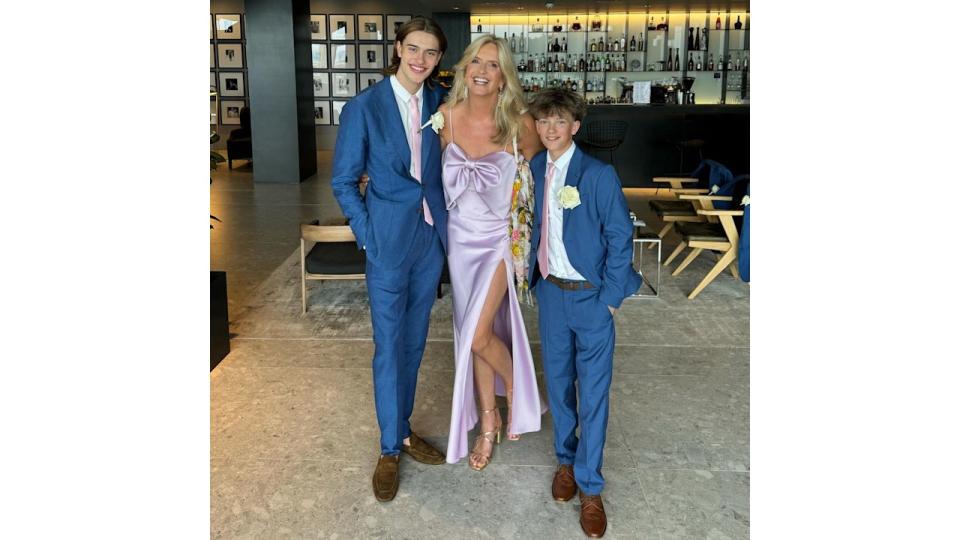 Penny Lancaster in lilac with two sons