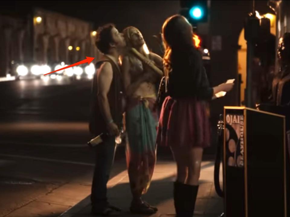 A red arrow pointing to a couple outside a movie theater in the film "Easy A."