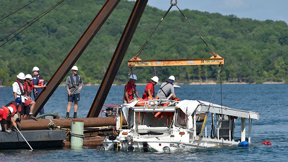 A crew used a barge and a crane to pull a duck boat to the surface Monday, July 23, 2018. The boat sank in Table Rock Lake near Branson, Missouri, on Thursday, July 19, 2018, killing 17.