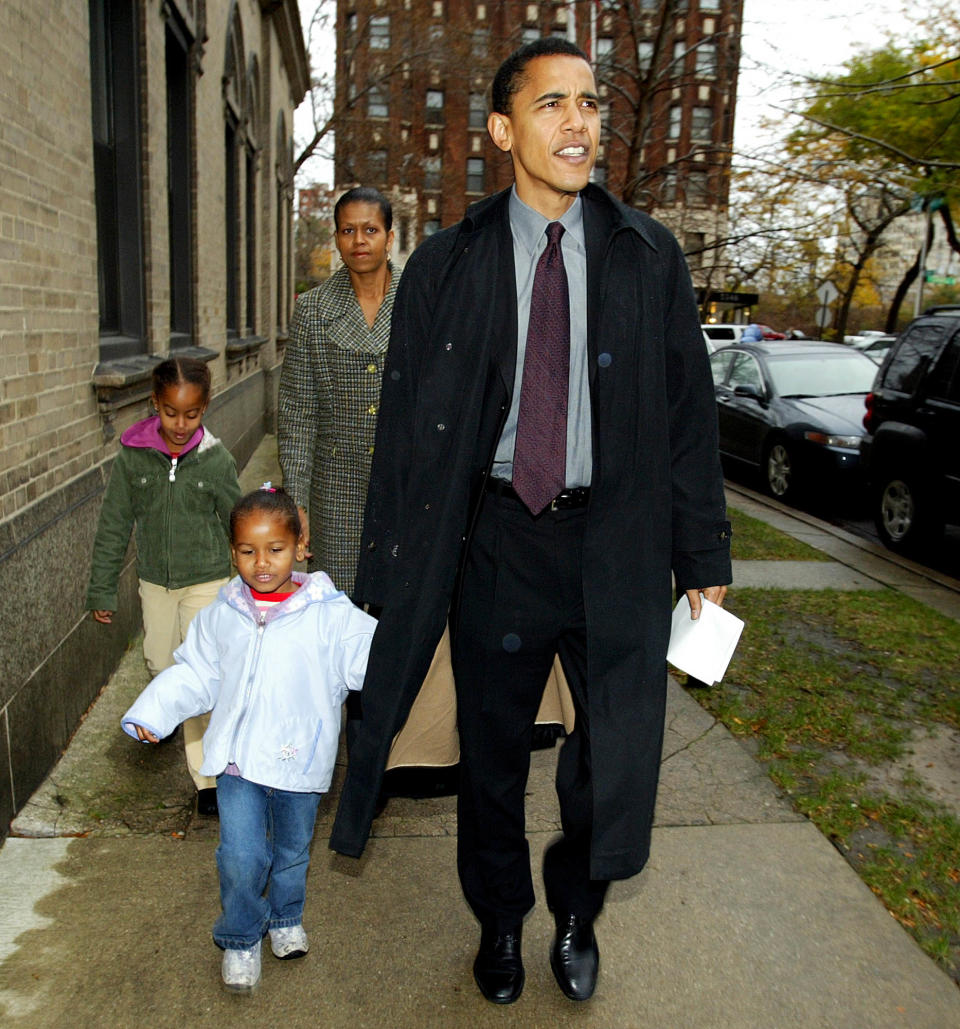 Then-Illinois Democratic Senate candidate Barack Obama leaves with his wife Michelle, daughters Sasha, front left, and Malia after voting at Catholic Theological union polling place in Chicago on Nov. 2, 2004.