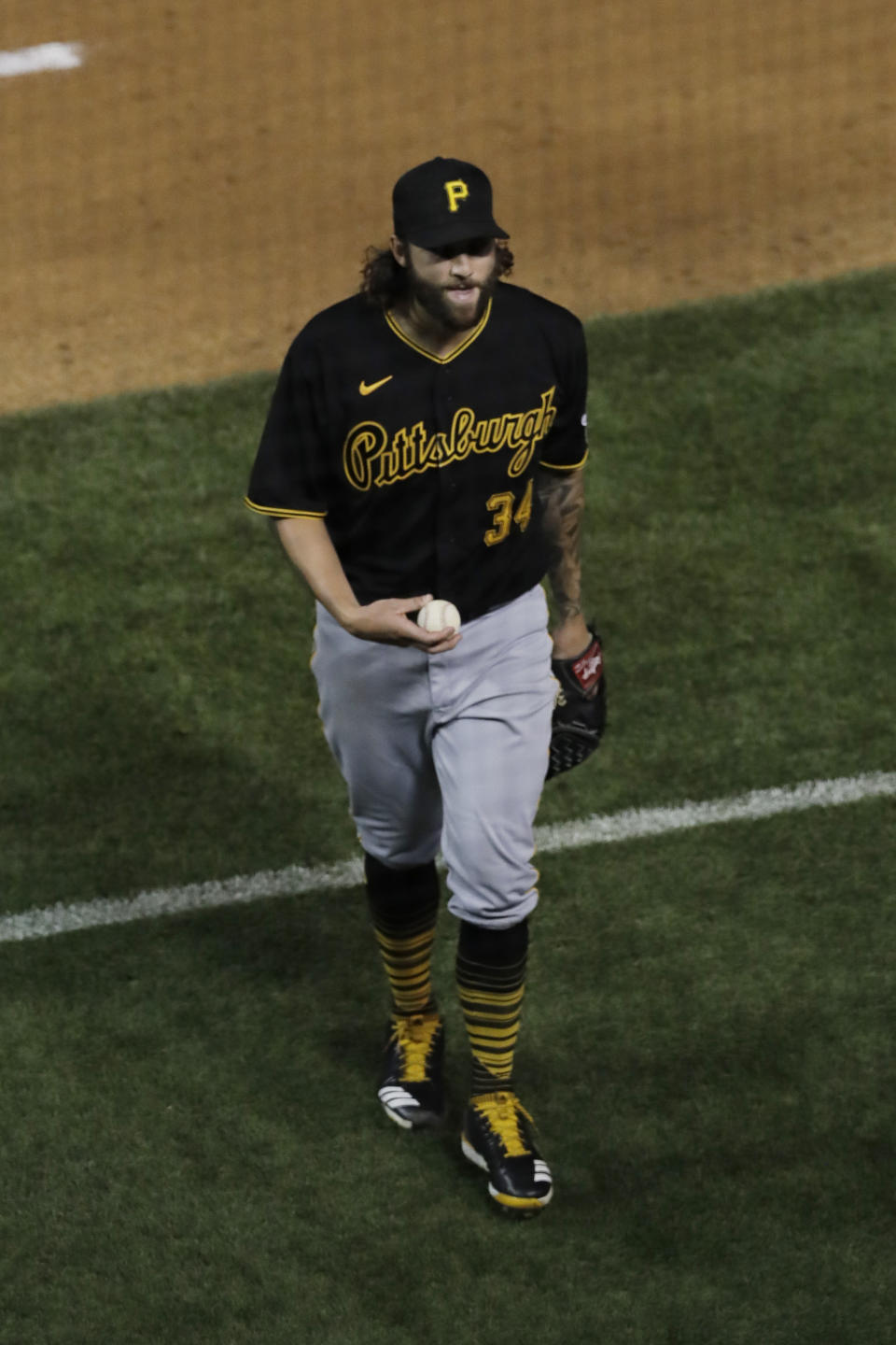 Pittsburgh Pirates starting pitcher Trevor Williams holds the baseball as he walks to the dugout after the fourth inning of a game against the Chicago Cubs in Chicago, Friday, July 31, 2020. (AP Photo/Nam Y. Huh)