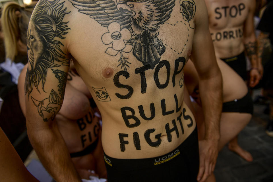 <p>Demonstrators stand in front of city hall during a protest against bullfighting a day before the San Fermín festival in Pamplona, Spain. (Photo: Alvaro Barrientos/AP) </p>