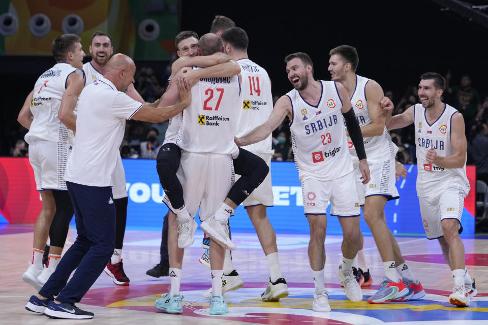 Serbian players celebrate their win over Canada in a Basketball World Cup semi final game in Manila, Philippines, Friday, Sept. 8, 2023. (AP Photo/Michael Conroy)