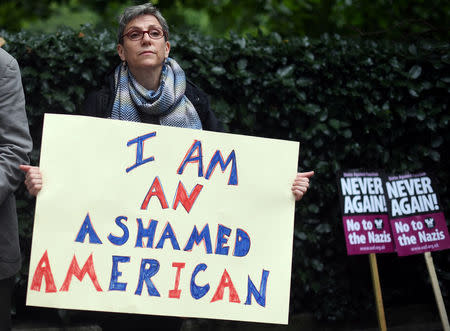 A demonstrator holds a placard during an anti-fascist protest outside the U.S Embassy in London, Britain, August 14, 2017. REUTERS/Hannah McKay