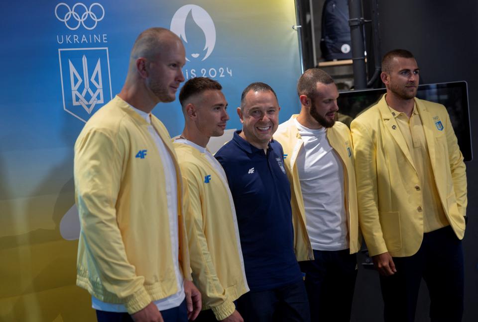 President of the National Olympic Committee of Ukraine Vadym Gutzeit poses for pictures with the kayak four team, Igor Trunov, Oleh Kukharyk, Dmytro Danylenko and Ivan Semykin, before the presentation of the Ukrainian team outfits for the Paris 2024 Olympic Games designed by the 4F sportswear brand in Kyiv, Ukraine (REUTERS)