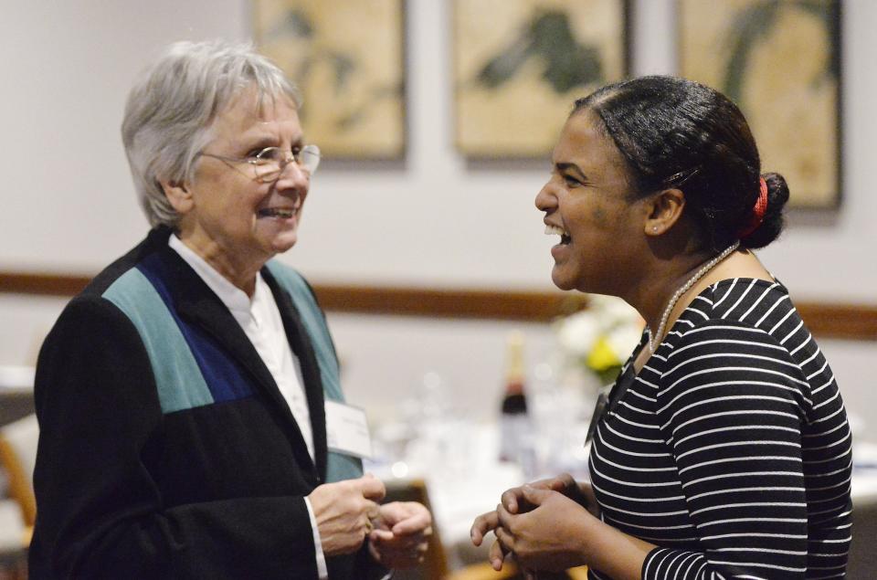 Sister Mary Miller, at left, meets with Walaa Ahmad on Jan. 17, 2019 for Erie's first People's Supper at the Erie Insurance Events Center.