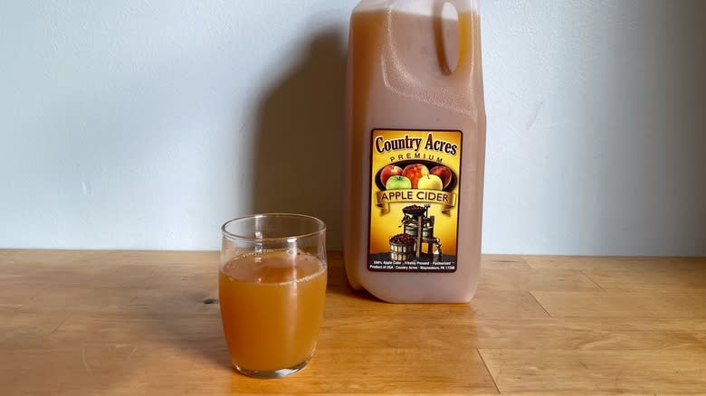 Half-gallon of Country Acres cider with glass cup