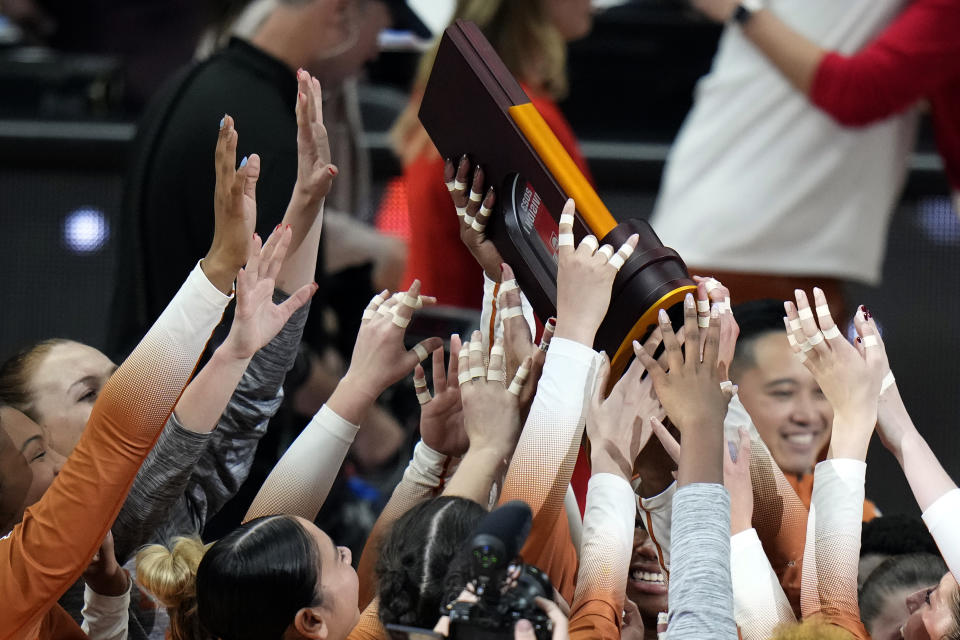 Texas players celebrate after winning the NCAA Division I women's college volleyball tournament against Nebraska Sunday, Dec. 17, 2023, in Tampa, Fla. (AP Photo/Chris O'Meara)