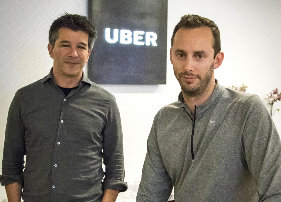 FILE - In this Aug. 18, 2016, file photo, Uber CEO Travis Kalanick, left, and Anthony Levandowski, co-founder of Otto, pose for a photo in the lobby of Uber headquarters, in San Francisco. Former Uber CEO Kalanick returned to a courtroom Wednesday, Feb. 7, 2018, to deal with questions about his discussions with Levandowski, an engineer accused of stealing Google’s self-driving car technology. (AP Photo/Tony Avelar, File)