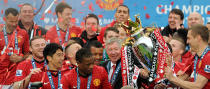 Manchester United manager Sir Alex Ferguson celebrates with the Barclays Premier League trophy after the Barclays Premier League match at Old Trafford, Manchester.