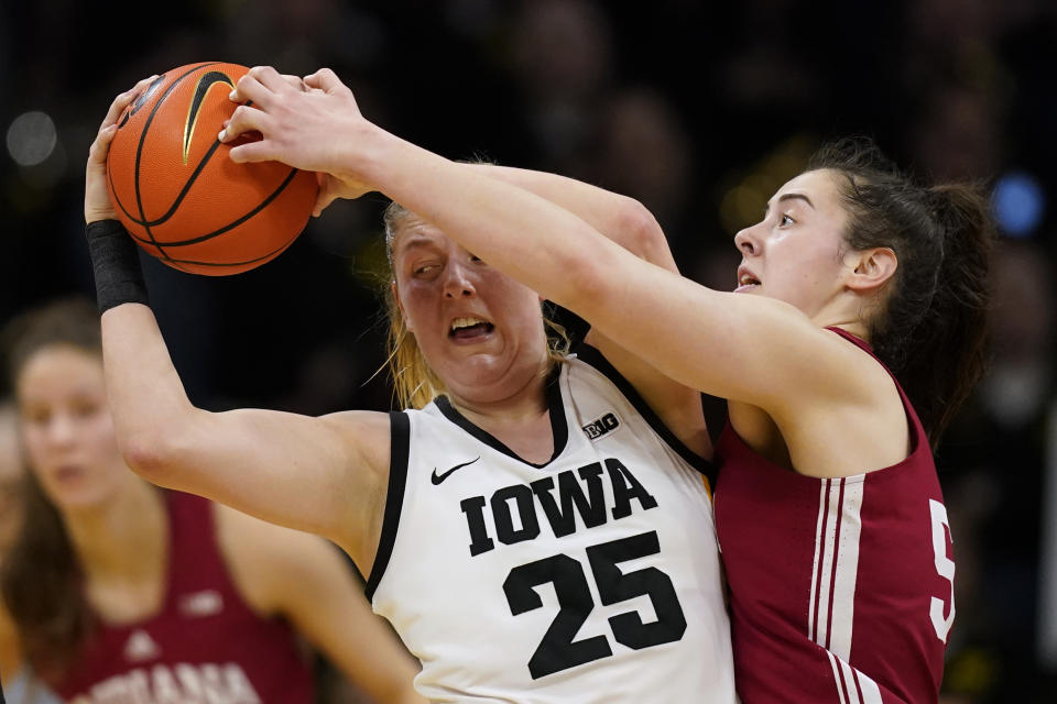 Indiana forward Mackenzie Holmes, right, tries to steal the ball from Iowa forward Monika Czinano (25) during the first half of an NCAA college basketball game, Sunday, Feb. 26, 2023, in Iowa City, Iowa. (AP Photo/Charlie Neibergall)