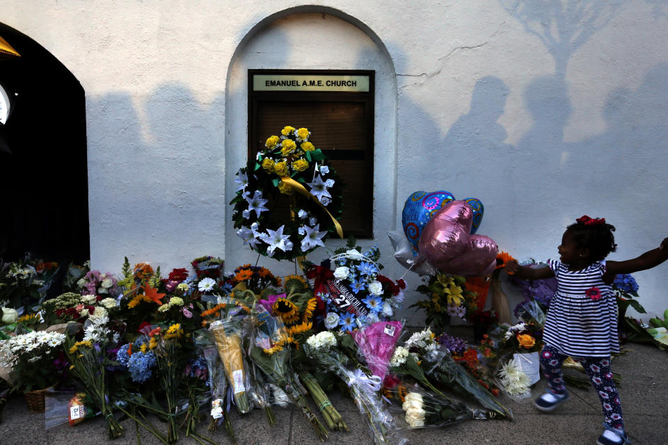 FILE - In this June 18, 2015, file photo, mourners pass by a makeshift memorial on the sidewalk in front of the Mother Emanuel AME Church following the shooting of nine Black parishioners in Charleston, S.C. (AP Photo/Stephen B. Morton, File)