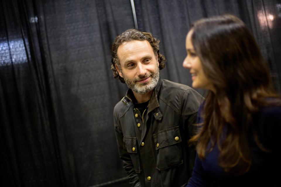 Andrew Lincoln, left, who plays Rick Grimes on the cable TV show "The Walking Dead," walks through Walker Stalker Con, a convention based off the show, with fellow cast member Sarah Wayne Callies, right, Saturday, Nov. 2, 2013, in Atlanta. For Lincoln, acting out the battle scenes in downtown Atlanta during the first season of “The Walking Dead” was a joyous time. Here was the British actor, on the same streets where Confederate forces battled Union troops in the American Civil War, shooting his way through a foreboding urban landscape now over-run by flesh-devouring “walkers.” “It was one of the greatest weekends of my career, you know,” he says, his eyes lighting up with excitement. “We shut down four blocks of downtown Atlanta and I get to ride into the city on a horse. It was epic. (AP Photo/David Goldman)