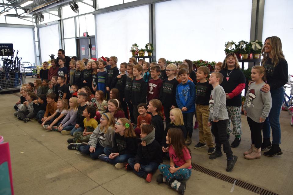 Charlevoix Elementary School second graders smile for a photo after going on a Walmart toy shopping spree for children in need.