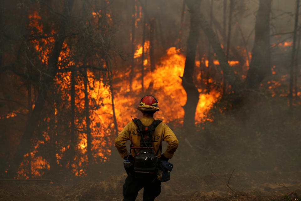 A Cal Fire firefighter monitors flames in Calistoga, California, earlier this month. (Photo: Stephen Lam/Reuters)