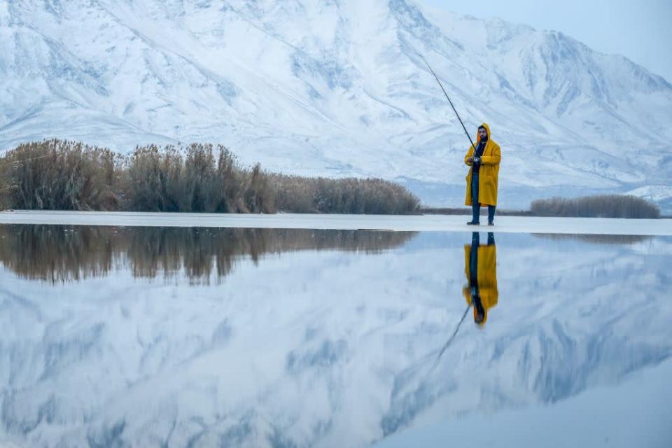 <p>A Man walk try to catch fishes on a frozen lake as it is zero celcius degree in Van, Turkey. (Ozkan Bilgin/Anadolu Agency/Getty Images) </p>