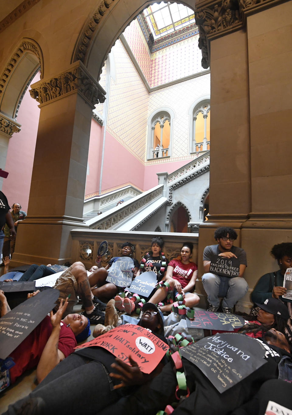 Protesters from VOCAL NY lay on the floor outside the Assembly Chamber urging legislators to pass legalization of Marijuana legislation at the state Capitol Wednesday, June 19, 2019, in Albany, N.Y. (AP Photo/Hans Pennink)