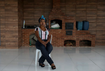 Rose Nascimento, 50, a businesswoman, and supporter of Brazil's presidential candidate Jair Bolsonaro, poses for a portrait outside her house in Rio de Janeiro, Brazil, October 17, 2018. REUTERS/Pilar Olivares