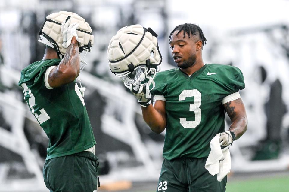 Michigan State running back Jordon Simmons, left, and Jarek Broussard talk during a break in practice on Thursday, Aug. 4, 2022, in East Lansing.