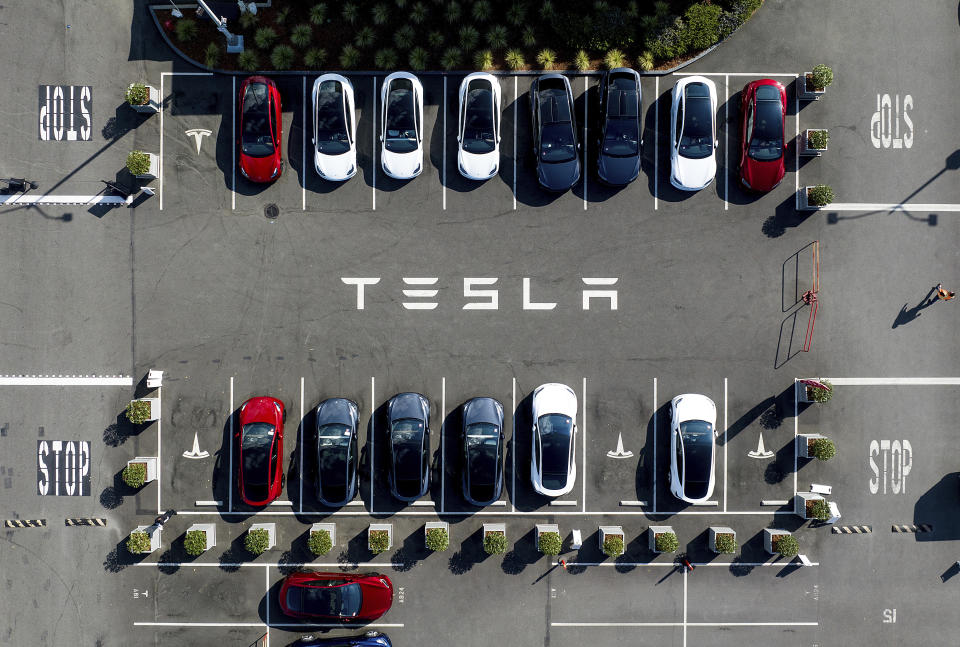 FILE - Tesla vehicles line a parking lot at the company's Fremont, Calif., factory, on Sept. 18, 2023. Tesla's stock is faltering before the market open on Thursday as the electric vehicle, solar panel and battery maker cautioned on slower sales growth this year and posted weaker-than-expected quarterly earnings. (AP Photo/Noah Berger, File)