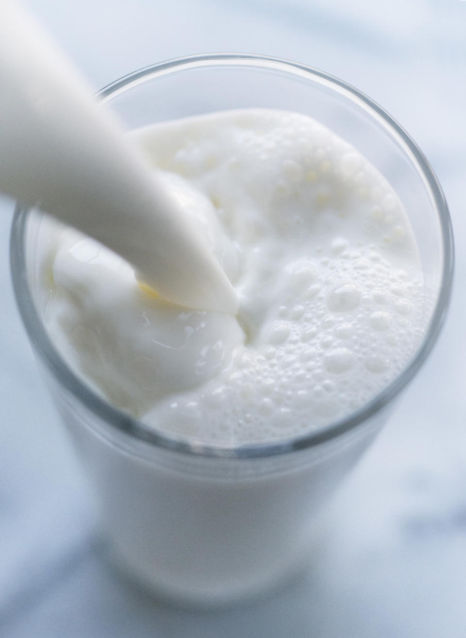 Pouring milk into a glass.