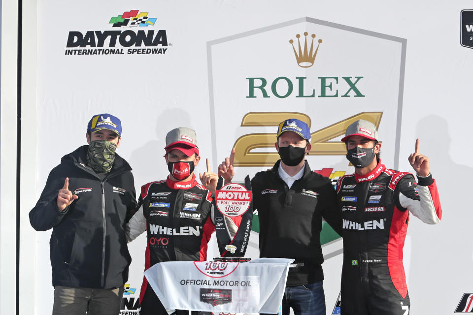 From left to right, Chase Elliot, Pipo Derani, Mike Conway and Felipe Nasr celebrate in Victory Lane after winning a qualifying race for the Rolex 24 hour auto race at Daytona International Speedway, Sunday, Jan. 24, 2021, in Daytona Beach, Fla. The No. 31 Wheelen Engineering Racing Cadillac DPi will have the pole position for the Rolex 24 hour race. (AP Photo/David Graham)