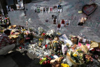 <p>A man looks at flowers and messages left near Grenfell Tower in London, Saturday, June 17, 2017. Police Commander Stuart Cundy said Saturday it will take weeks or longer to recover and identify all the dead in the public housing block that was devastated by a fire early Wednesday. (AP Photo/Kirsty Wigglesworth) </p>