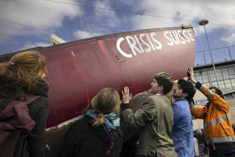 Protesters demonstrate with a boat at the entrance of Swiss bank Credit Suisse during the annual shareholders' meeting of the Swiss banking group, in Zurich, Switzerland, on Tuesday, April 4, 2023. Once-venerable Credit Suisse is heading into a possible firestorm Tuesday as shareholders meet for what is shaping up to be their last crack at managers following a colossal collapse of the bank’s stock price over the last decade and as rival UBS is set to gobble up the 167-year-old Swiss lender at a bargain-basement price.(Michael Buholzer/Keystone via AP)