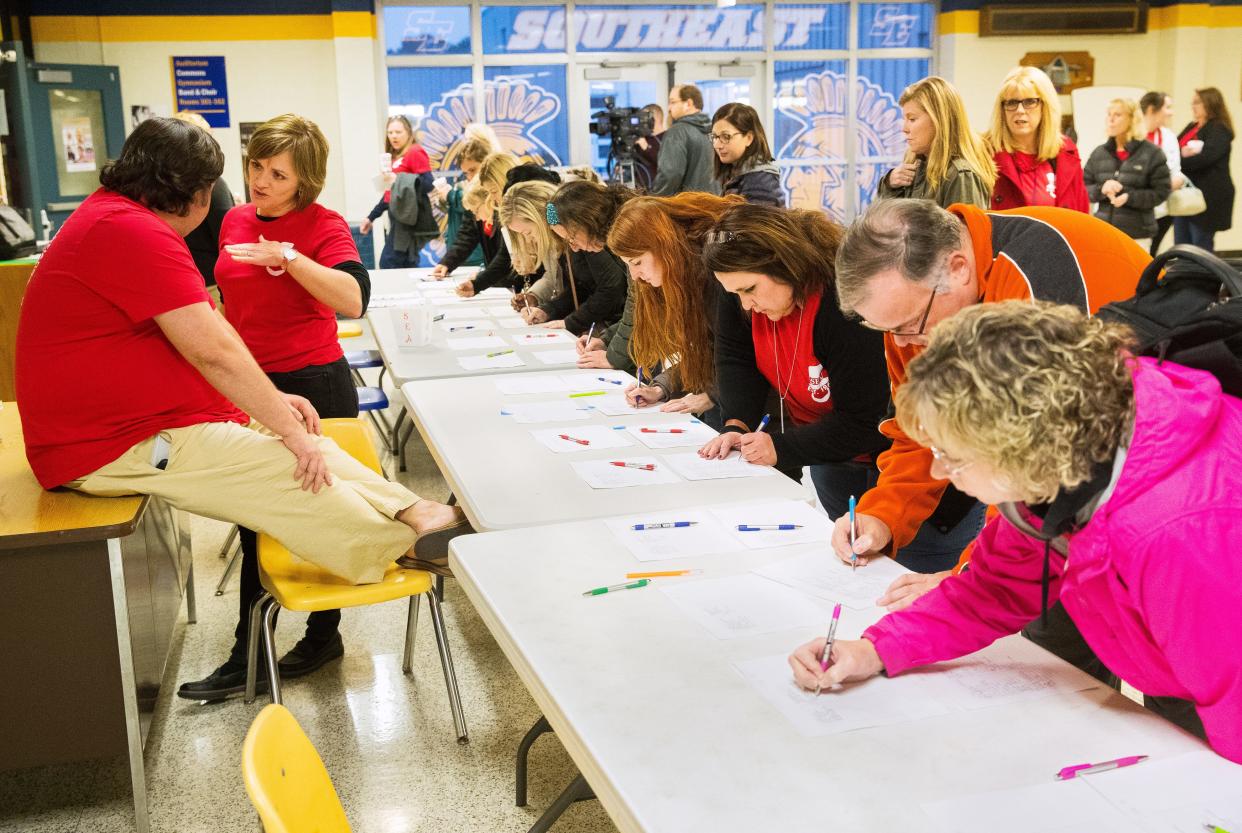 Members of the Springfield Education Association sign in before a meeting at Southeast High School to consider an offer by Springfield School District 186 Monday, Nov. 4, 2019. SEA members hold a ratification vote at Springfield High School Tuesday.